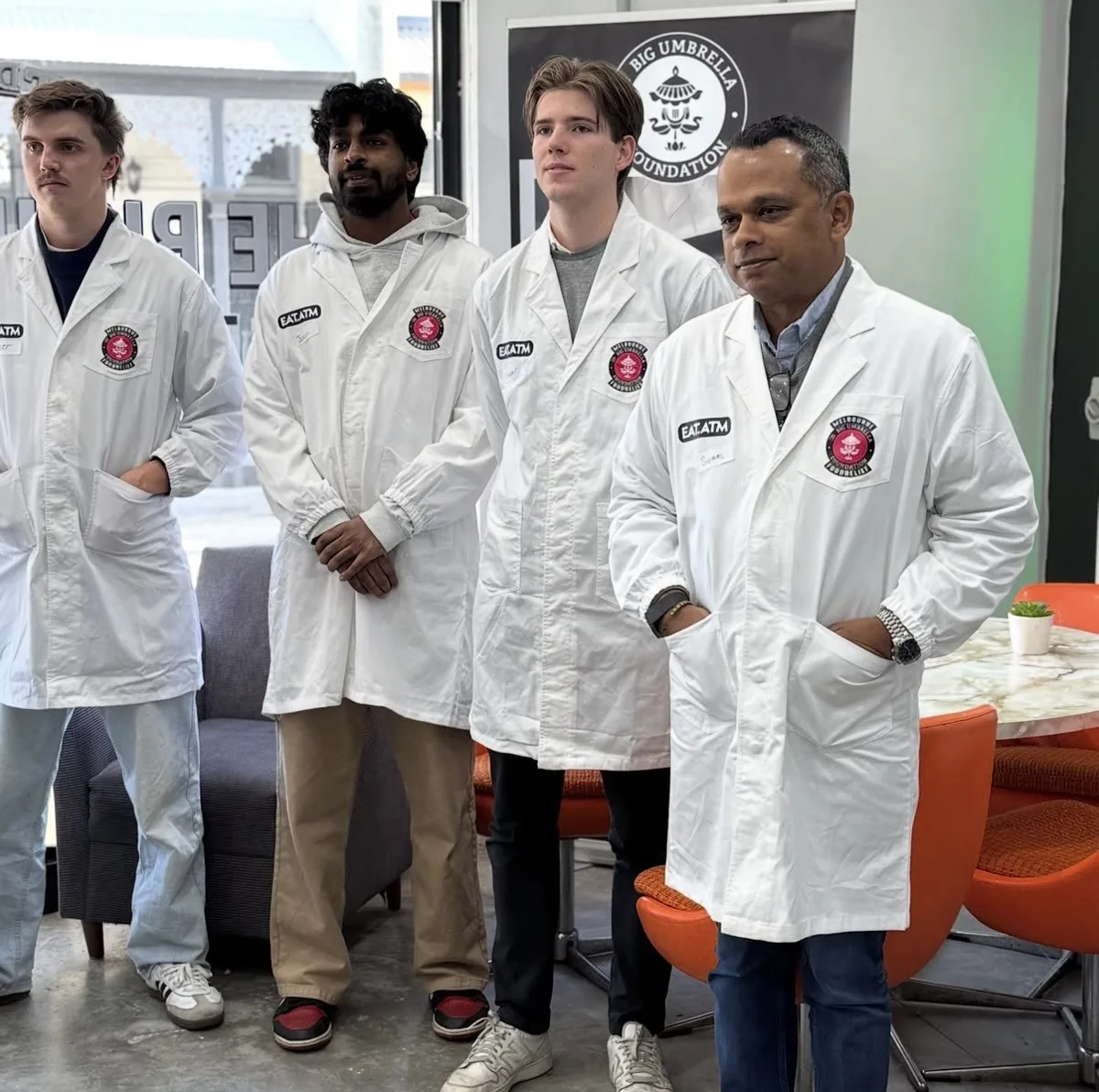 RedOwl team members in volunteer coats at The Big Umbrella Foundation